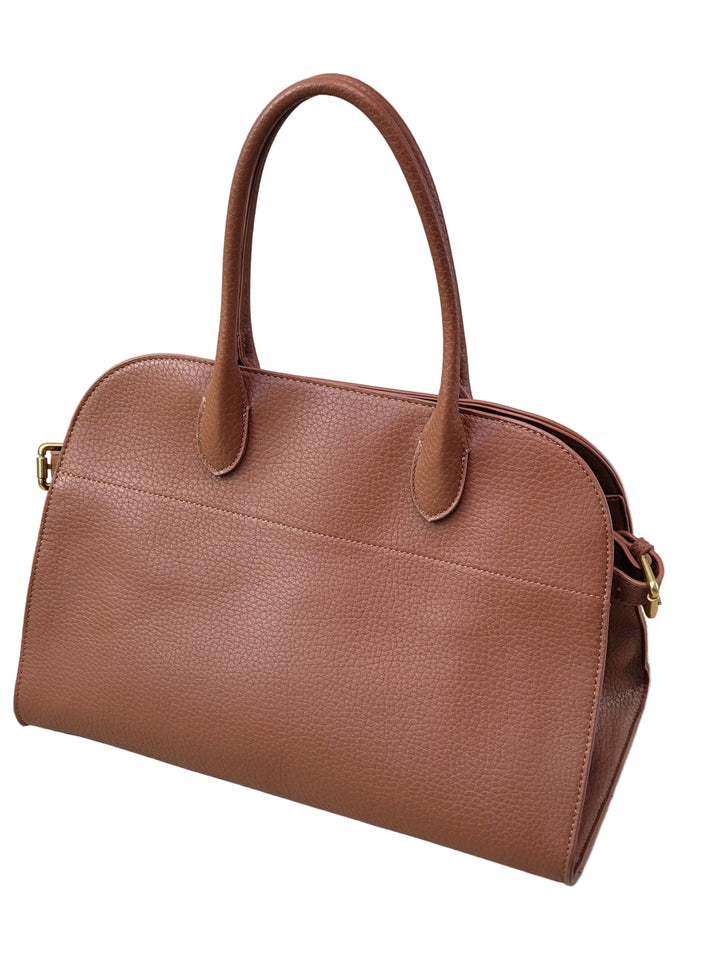 Brown leather handbag on a light wooden floor