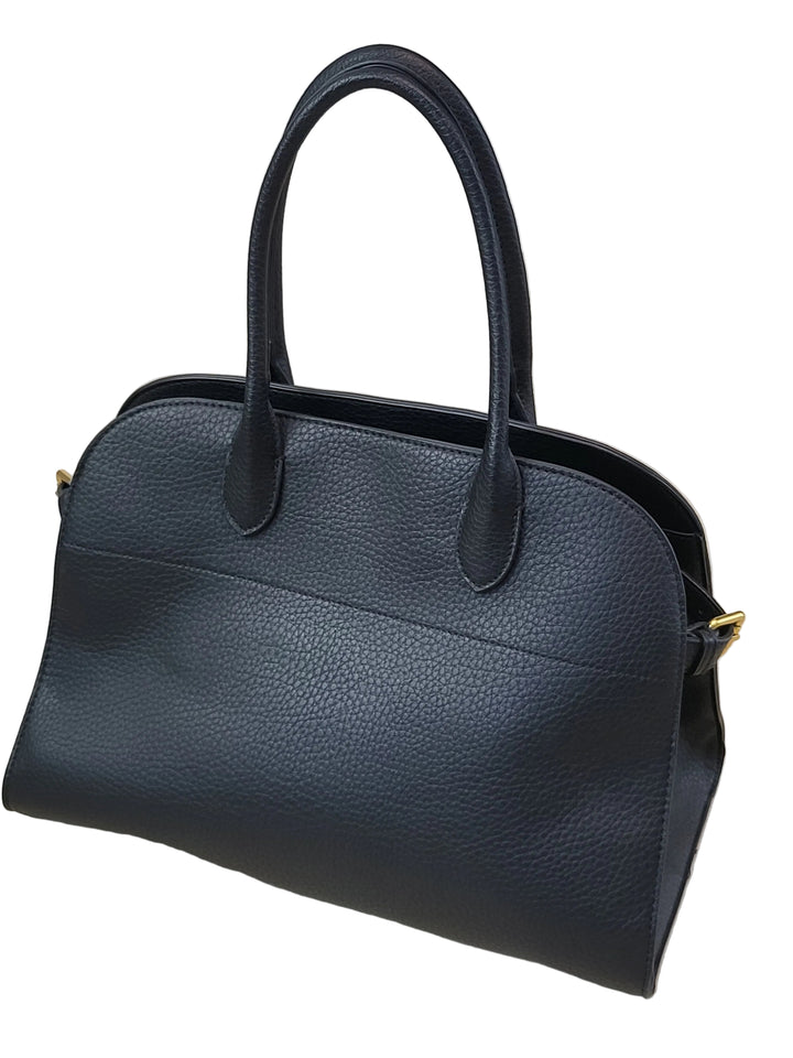 Black leather handbag on a light wooden surface